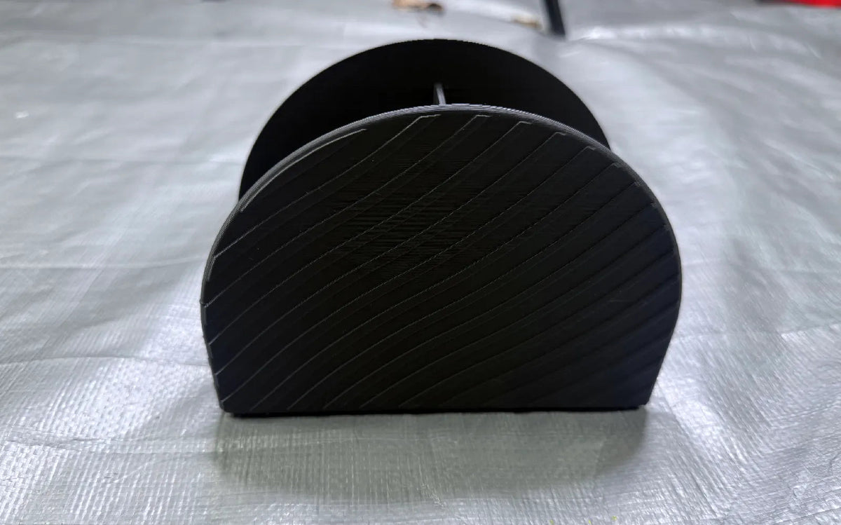 3D printed remote control holder side view showing textured design